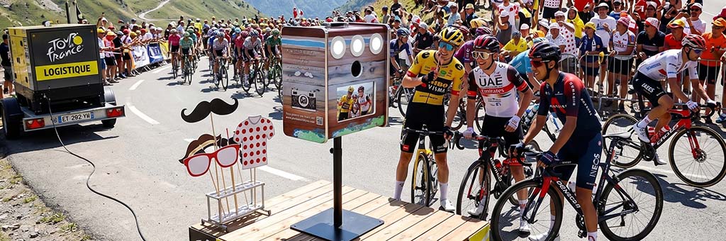 Photobooth installé lors d'une course cycliste en montagne avec des coureurs et des supporters